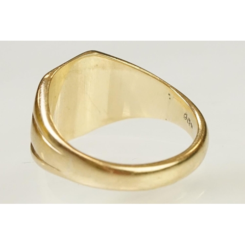 122 - 9ct gold signet ring having a square head with reeded shoulders. Marked 9ct to shank. Head engraved ... 