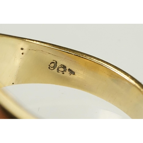 122 - 9ct gold signet ring having a square head with reeded shoulders. Marked 9ct to shank. Head engraved ... 