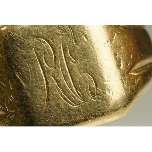 122 - 9ct gold signet ring having a square head with reeded shoulders. Marked 9ct to shank. Head engraved ... 