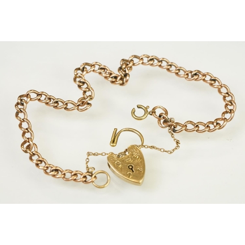 123 - 9ct gold heart padlock mounted to a curb link rose metal bracelet. Bracelet hallmarked London 1957. ... 