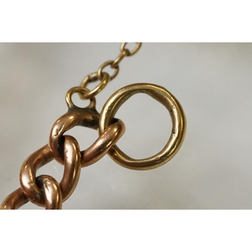 123 - 9ct gold heart padlock mounted to a curb link rose metal bracelet. Bracelet hallmarked London 1957. ... 