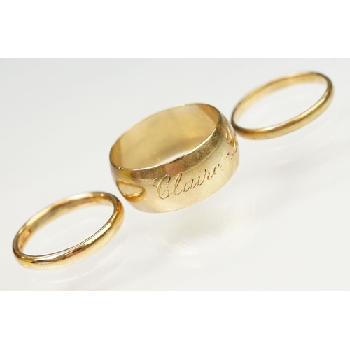 128 - Three 9ct gold hallmarked wedding band rings. The lot to include a wide band ring engraved Claire Lo... 