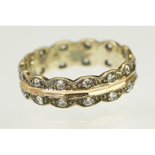 132 - 9ct gold hallmarked two tone eternity ring. The ring having a faceted rose gold centre with scallope... 