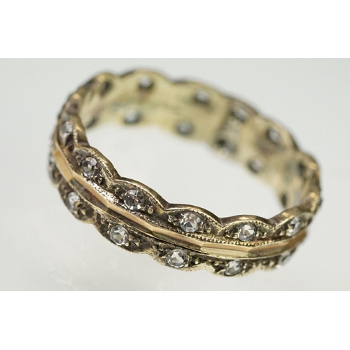 132 - 9ct gold hallmarked two tone eternity ring. The ring having a faceted rose gold centre with scallope... 