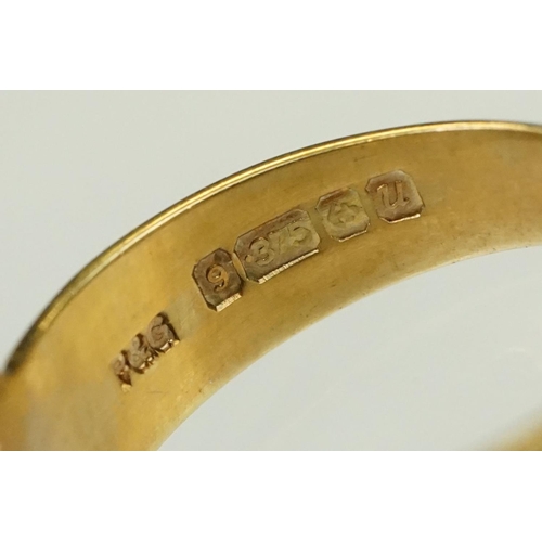 138 - Two 9ct gold rings to include a buckle ring (hallmarked Birmingham 1994, size H.5) together with a u... 