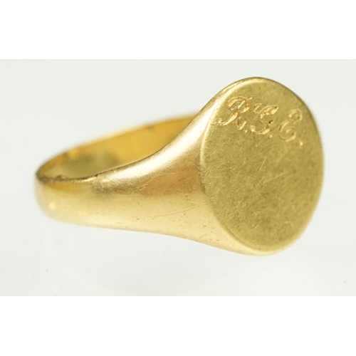 144 - 18ct gold hallmarked signet ring. The ring having an oval head with engraved initials. Partial hallm... 