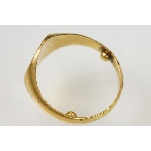 144 - 18ct gold hallmarked signet ring. The ring having an oval head with engraved initials. Partial hallm... 