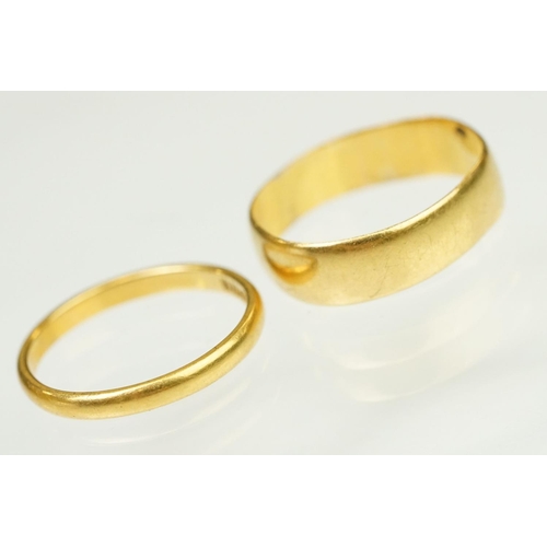 148 - Two hallmarked 22ct gold band rings to include a wide band (hallmarked Birmingham 1908, size N, off ... 