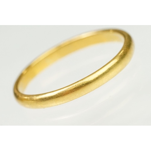 148 - Two hallmarked 22ct gold band rings to include a wide band (hallmarked Birmingham 1908, size N, off ... 