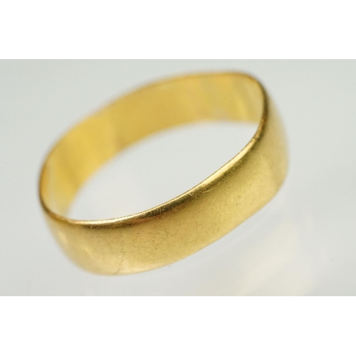 148 - Two hallmarked 22ct gold band rings to include a wide band (hallmarked Birmingham 1908, size N, off ... 