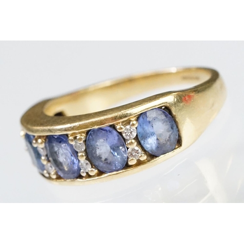 158 - 18ct gold tanzanite and diamond ring. The ring being set with five oval cut tanzanite's with round c... 