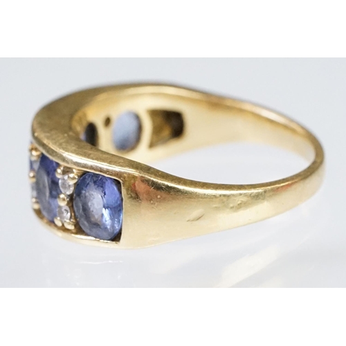 158 - 18ct gold tanzanite and diamond ring. The ring being set with five oval cut tanzanite's with round c... 