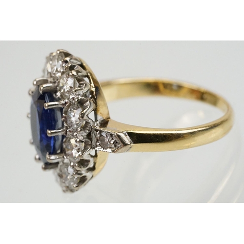 16 - 18ct gold, sapphire and diamond cluster ring being set with an oval mixed but clue sapphire with a h... 