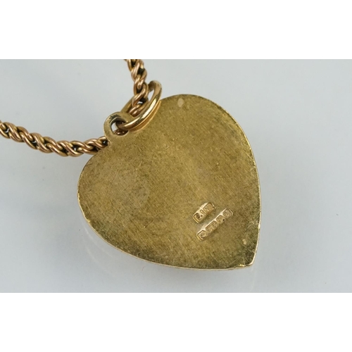 174 - Hallmarked 9ct gold St Christopher pendant necklace. The heart shape pendant suspended from a rope t... 