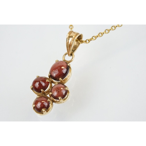 176 - 15ct gold and garnet cabochon pendant set with four cabochons with bale to top, mounted to a fine li... 