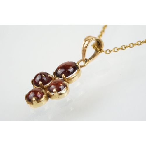 176 - 15ct gold and garnet cabochon pendant set with four cabochons with bale to top, mounted to a fine li... 