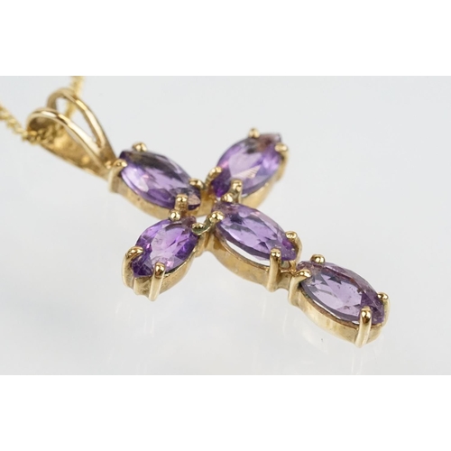 194 - 9ct gold and amethyst cross pendant necklace having a fine link chain with spring ring clasp, the pe... 