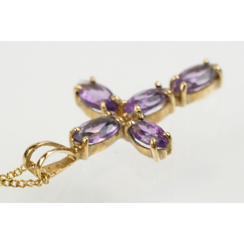 194 - 9ct gold and amethyst cross pendant necklace having a fine link chain with spring ring clasp, the pe... 