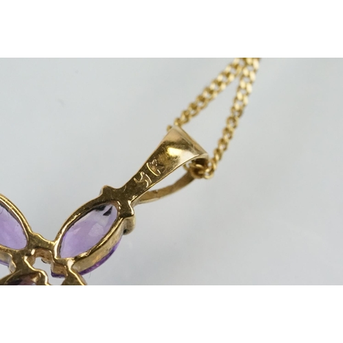 194 - 9ct gold and amethyst cross pendant necklace having a fine link chain with spring ring clasp, the pe... 