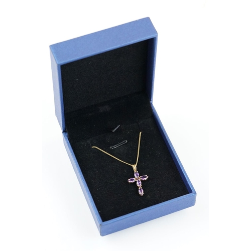 194 - 9ct gold and amethyst cross pendant necklace having a fine link chain with spring ring clasp, the pe... 