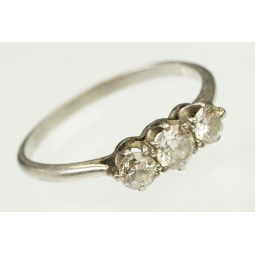 20 - Platinum and diamond three stone ring. The ring being set with three round brilliant cut diamonds in... 