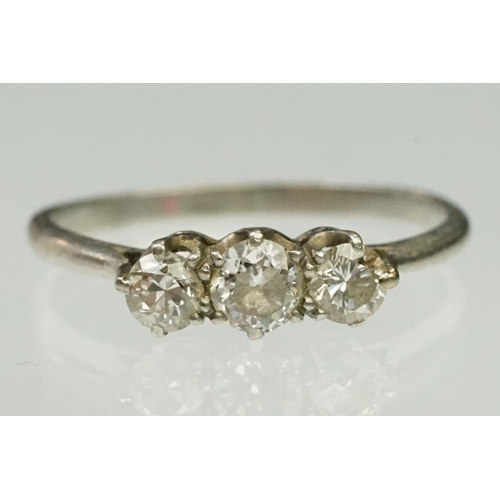 20 - Platinum and diamond three stone ring. The ring being set with three round brilliant cut diamonds in... 