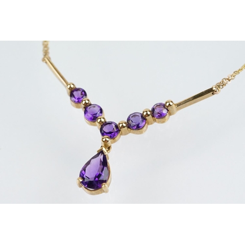 221 - 9ct gold hallmarked amethyst collar necklace having a pear cut amethyst and five round cut amethysts... 