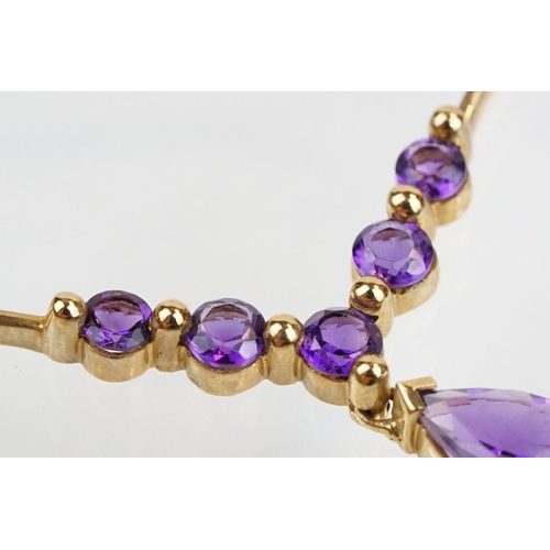 221 - 9ct gold hallmarked amethyst collar necklace having a pear cut amethyst and five round cut amethysts... 