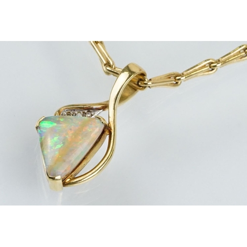 259 - 18ct gold, opal and diamond pendant necklace. The necklace having a triangular boulder opal set with... 