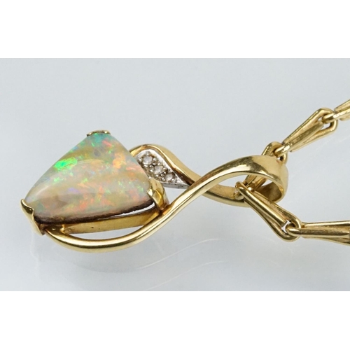 259 - 18ct gold, opal and diamond pendant necklace. The necklace having a triangular boulder opal set with... 