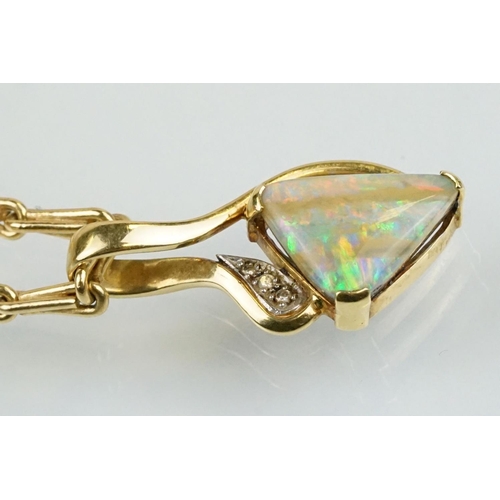 259 - 18ct gold, opal and diamond pendant necklace. The necklace having a triangular boulder opal set with... 