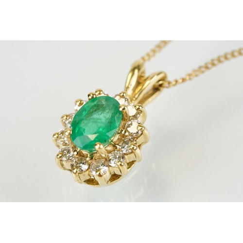 262 - Emerald and diamond halo pendant set to 9ct gold trace chain. The pendant set with an oval cut emera... 