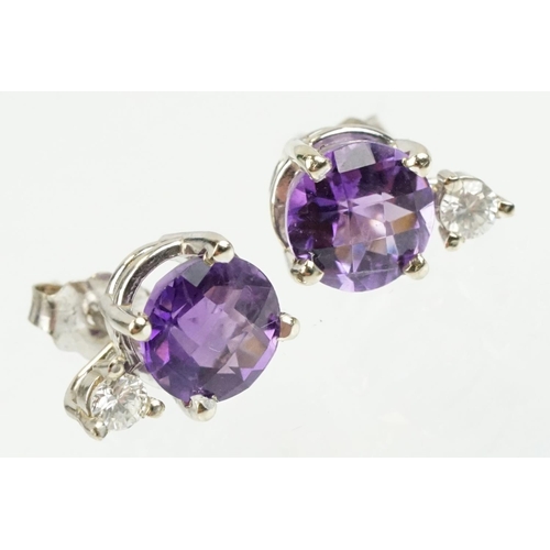 263 - Pair of 14ct gold stud earrings being set with two rose cut round amethysts with two round brilliant... 