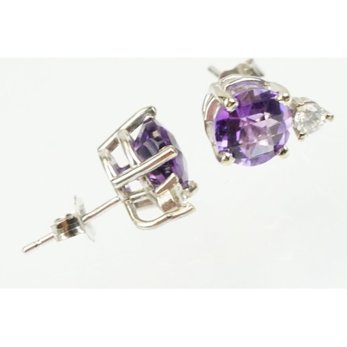 263 - Pair of 14ct gold stud earrings being set with two rose cut round amethysts with two round brilliant... 