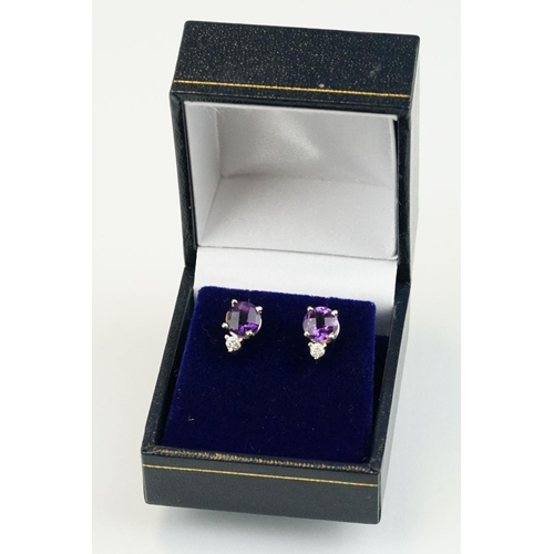 263 - Pair of 14ct gold stud earrings being set with two rose cut round amethysts with two round brilliant... 