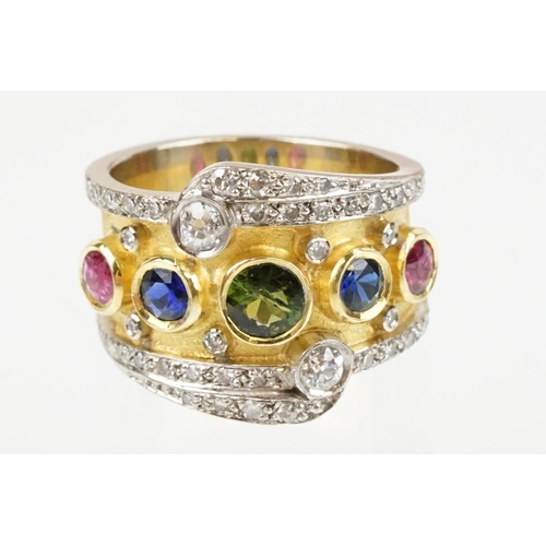 264 - 18ct gold, ruby, sapphire and diamond ring. The ring bezel set with a green round cut sapphire to ce... 