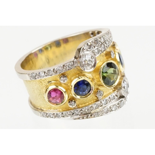 264 - 18ct gold, ruby, sapphire and diamond ring. The ring bezel set with a green round cut sapphire to ce... 