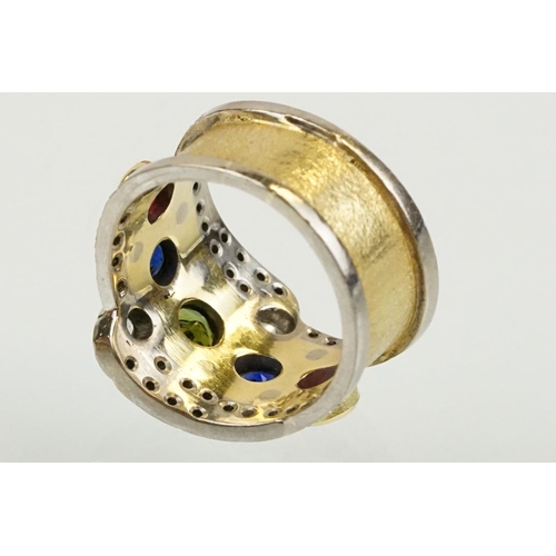 264 - 18ct gold, ruby, sapphire and diamond ring. The ring bezel set with a green round cut sapphire to ce... 