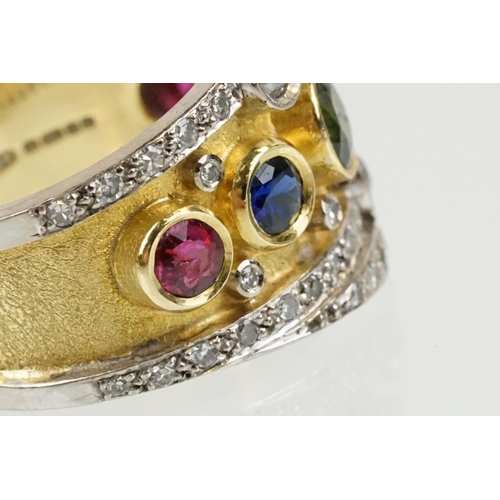 264 - 18ct gold, ruby, sapphire and diamond ring. The ring bezel set with a green round cut sapphire to ce... 