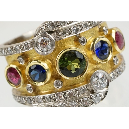 264 - 18ct gold, ruby, sapphire and diamond ring. The ring bezel set with a green round cut sapphire to ce... 