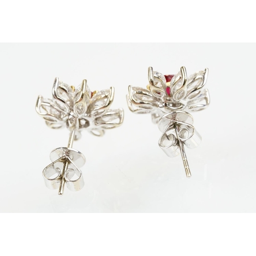 267 - Pair of 18ct white gold ruby and diamond cluster earrings each being set with round cut rubies to th... 