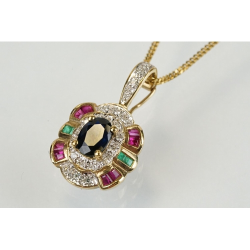 269 - 9ct gold sapphire, ruby, emerald and diamond pendant set with an oval cut sapphire to centre surroun... 