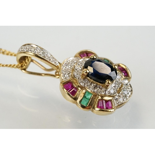 269 - 9ct gold sapphire, ruby, emerald and diamond pendant set with an oval cut sapphire to centre surroun... 