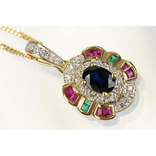 269 - 9ct gold sapphire, ruby, emerald and diamond pendant set with an oval cut sapphire to centre surroun... 