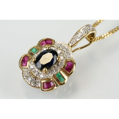 269 - 9ct gold sapphire, ruby, emerald and diamond pendant set with an oval cut sapphire to centre surroun... 