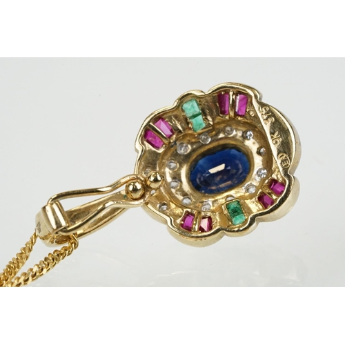 269 - 9ct gold sapphire, ruby, emerald and diamond pendant set with an oval cut sapphire to centre surroun... 