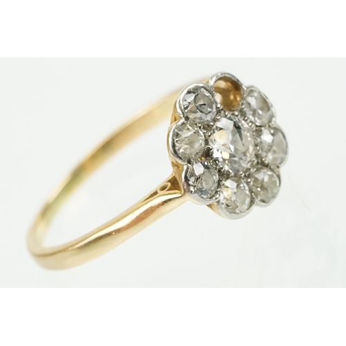 277 - Early 20th Century 18ct gold and diamond daisy cluster ring. The ring being set with eight old cut d... 