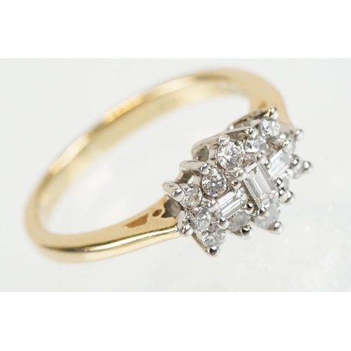 278 - 9ct gold and diamond cluster ring being set with three baguette cut diamonds surrounded by twelve ro... 