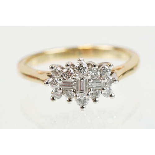 278 - 9ct gold and diamond cluster ring being set with three baguette cut diamonds surrounded by twelve ro... 