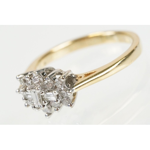 278 - 9ct gold and diamond cluster ring being set with three baguette cut diamonds surrounded by twelve ro... 